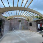 Curved glulam beams in timber roof design