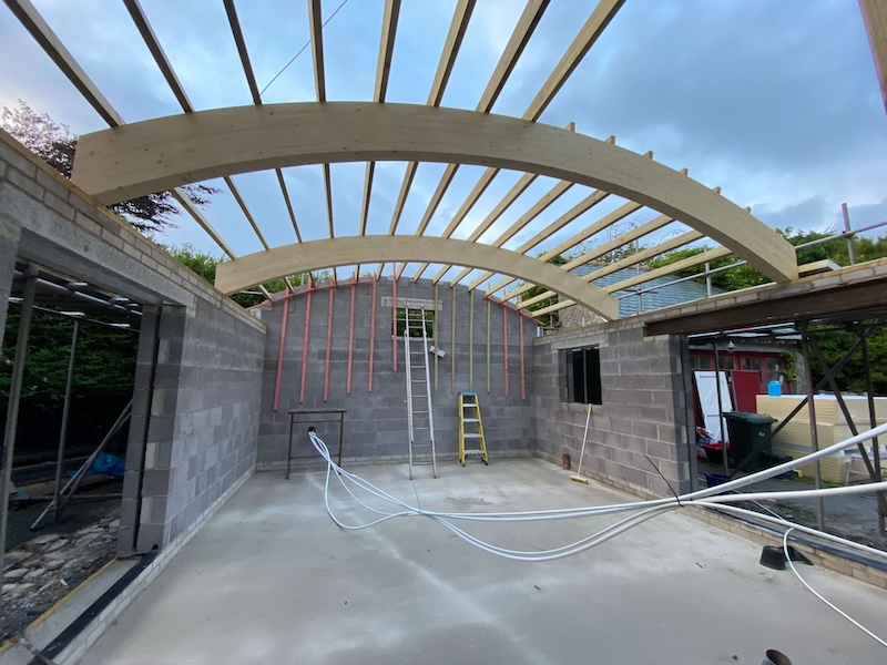 Curved glulam beams in timber roof design