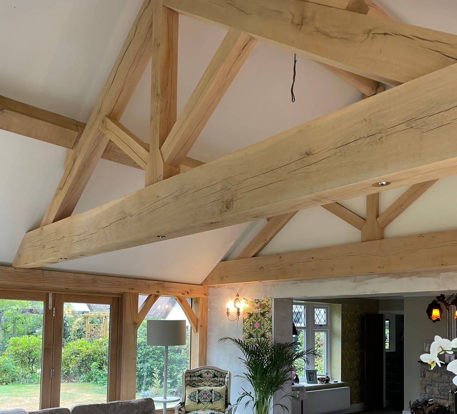 Bespoke oak feature truss installed in open-plan home extension building